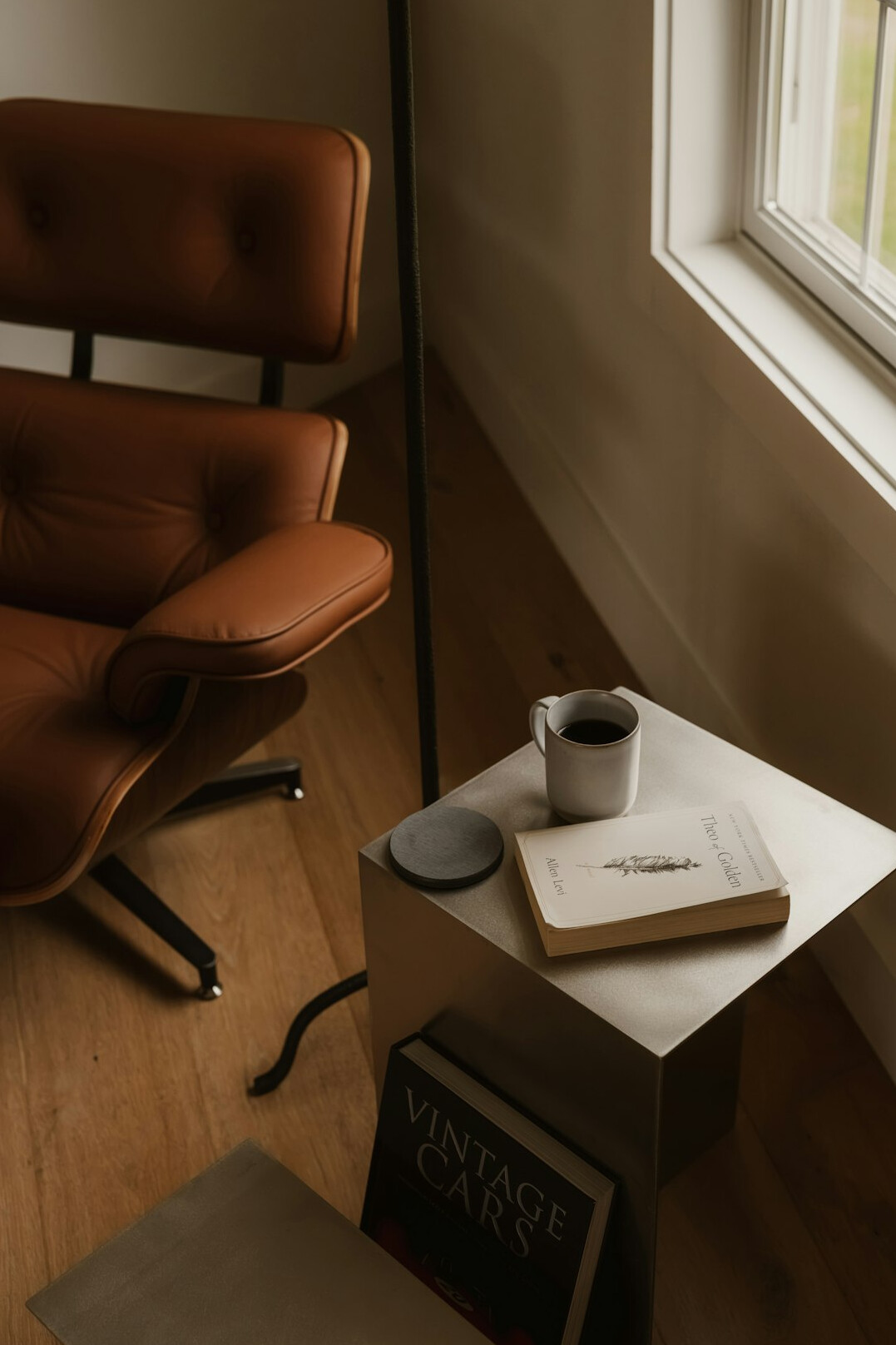 Reading corner with an armchair, lamp and bookshelf