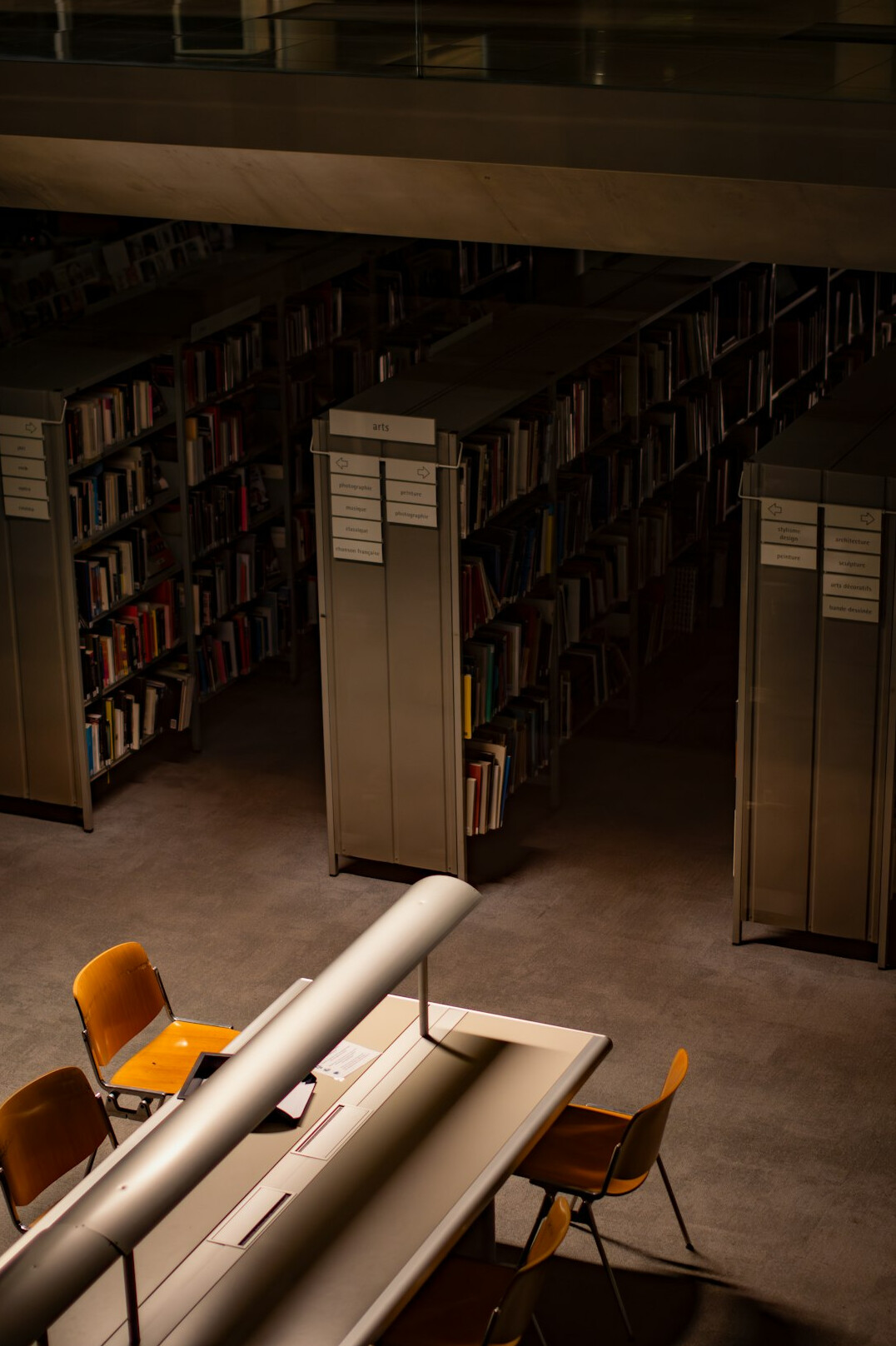 Bright research studio with a long table, books and papers