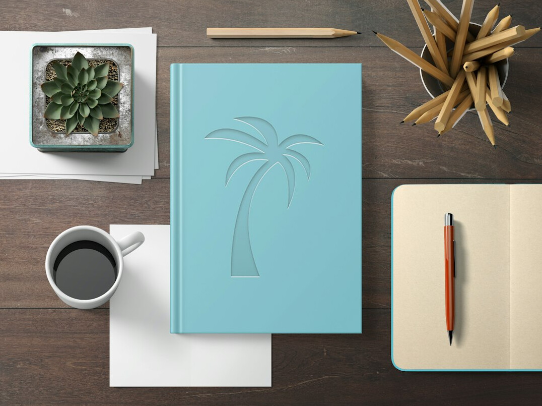 Open notebook and fountain pen on a wooden desk with coffee